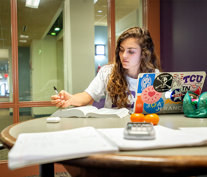 TCU Student studying in dorm